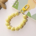 Stylish yellow pearlescent beaded wristband keychain with metallic lobster clasp and ring - Mermaid Iridescent Bead Charm / Yellow