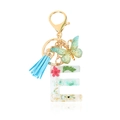 Letter E sleutelhanger met rode droogbloemen, blauwe kwast en vlinder hanger - Letter E