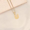Golden stainless steel necklace featuring a textured letter U pendant on a box chain - Letter U