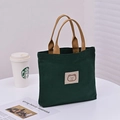 Dark green canvas tote bag with brown handles and a cute cartoon bear patch - Dark Green