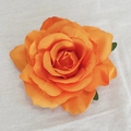 Top view of a single orange fabric rose head with green leaves on white texture - Orange