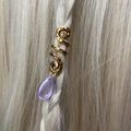 Detailed view of a gold spiral hair charm with purple teardrop bead on blonde braids - Purple Pendant
