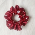 Elegant dark red satin scrunchie with white heart pattern on white fabric background - Heart Printed