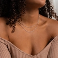 Close-up of double-layer silver snake chain necklace set worn on a model's neck - Twist Chain Silver