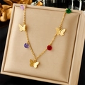Detail of layered gold necklace featuring butterfly charms and colorful gemstones in a box - Three Butterflies Multicolored Gemstone Style (N2254)
