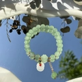 Exquisite green beaded bracelet with a white pendant and golden accents on a mirror surface - S048-white Jade Beaded Bracelet With Safety Buckle #sz347