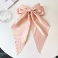 Large pale pink satin bow hair clip with elegant long ribbons in a soft silk finish - Champagne Pink