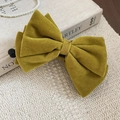 Detail of velvet bow hair clip in mustard yellow with soft flocking texture and clip - Yellow - Bow (Twist Clip)
