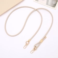 Detail of adjustable beige PU leather strap with golden metal clasps for cross-body bags - Off White