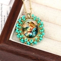 Close-up of Virgin Mary oval pendant with turquoise beads and gold metallic chain - Guadalupe Virgin Mary / Lake Blue
