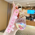 Pink keychain with a crystal oil acorn bottle filled with colorful candy and silicone strap - Quicksand Shell - Pine Cone