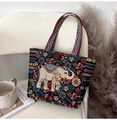 Detailed close-up of a black canvas tote with colorful elephant and floral embroidery - Apricot Elephant