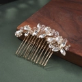 Close-up of golden bridal hair comb with glittering crystals on dark green surface - Intertwined Flower and Leaf Style (HS-J5280G)