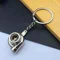 Detailed close-up of polished silver mini turbocharger keychain with realistic blade design - Turbocharger / Silver
