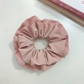 Detailed close-up of light pink faux leather scrunchie with layered pleats on white surface - Pink (Three-layer)