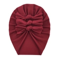 Close-up of soft burgundy cotton baby turban featuring three stylish knotted bows - Burgundy