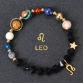 Macro shot of Leo zodiac natural stone bracelet with planets and gold star pendant - Leo-Faceted Stone
