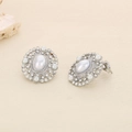 Macro detail of silver geometric stud earrings featuring central pearls and rhinestone halo - Steel Vintage Pearl Rhinestone Style (KE116344-KFC)
