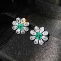 Flower-shaped silver earrings with white teardrop petals and a green square gemstone - Paraiba Green Stud Earrings
