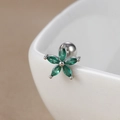 Macro shot of green zircon daisy flower stud earring on a white ceramic rim - 60126 Silver - Green Flower