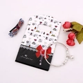 Mini plastic gift bag with red bow print and silver adjustable bell charm bracelet - No. 7 (Lipstick Icons)