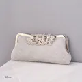 Elegant silver evening clutch bag with sparkling rhinestones and leaf clasp detail - Silver