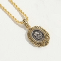 Vintage oval relief portrait pendant with two-tone gold and silver finish on a rope chain - Oval Hollow Relief Pendant