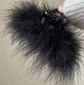 Elegant large black ostrich feather hair claw clip held by a hand for winter styling - Fluffy Turkey Feather Hair Claw / 284 Large - Turkey Feather