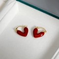 Elegant gold-tone hoop earrings with deep red enamel heart charms in a jewelry box - Burgundy