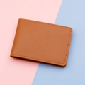 Slim brown lychee grain leather card holder with fine stitching on a bicolor background - Brown