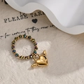 Chic beaded stretch ring featuring colorful metallic beads and a golden winged heart charm - Winged Heart Lock Charm