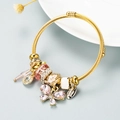 Detail of adjustable gold bangle with pink crystal butterfly charm and sparkling beads - Pink