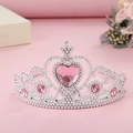 Detail view of silver plastic crown featuring a pink heart gem for princess costumes - Pink