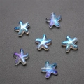 Macro shot of 7 blue-purple iridescent starfish-shaped glass crystal charms for DIY jewelry - Pack of 30 / Imported Colorful