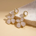 Detail of elegant gold flower earrings with white enamel petals on a stone surface - Silver Earring Post-White