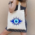 White canvas tote bag featuring a large blue and white Greek Evil Eye graffiti print - STD1804-E Blue & White Evil Eye