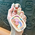 Creamy white TV-shaped keychain with cute sleeping Capybara illustration and gold clasp - Sliding Game Console - Brown