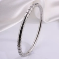 Minimalist silver stainless steel segmented bangle bracelet on elegant white satin fabric - Snake Style / Silver