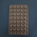 Brown 50-cavity silicone semi-sphere mold for chocolate and baking on blue background - Double Sided 24 Holes / Brown