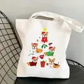 White Corgi canvas tote bag with Christmas cartoon dog print on a metal chair - C3-Christmas Corgi Tree