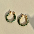 2.5cm gold-plated hoop earrings with green zircon crystals on a marble surface - Green