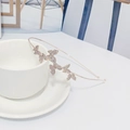 Elegante diadema de metal oro rosa con mariposas de strass sobre una taza blanca - Oro Rosa Circón AB