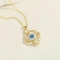 Golden necklace featuring a blue evil eye pendant with celestial moon and star elements - Circular Design