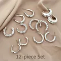 Close-up of a 12-piece silver C-shaped earring set on elegant beige satin fabric - 39# Silver Pin (12-Piece Set) / Silver