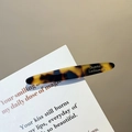 Elegant tortoiseshell barrette hair clip made of acetate with gold lettering detail - Dark Leopard Print