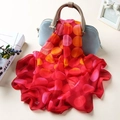 Red chiffon scarf with orange polka dots draped elegantly over a blue handbag - Large Polka Dot Red