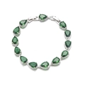 Macro detail of tear-drop emerald bracelet with silver base and crystal halo - Green