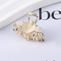 Detailed view of a gold-tone mini heart and wing hair claw clip with white faux pearls - 12# Pearl Heart Claw Clip