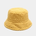 Close-up of soft yellow lamb wool bucket hat with warm plush texture and high density fiber - M / Yellow