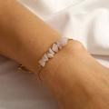 Detail of pink rose quartz natural stone bracelet with adjustable gold chain on wrist - Pink Rose Quartz
